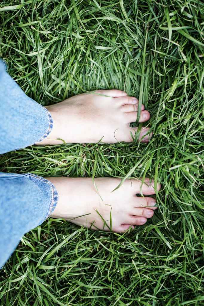 Bare feet standing on grass