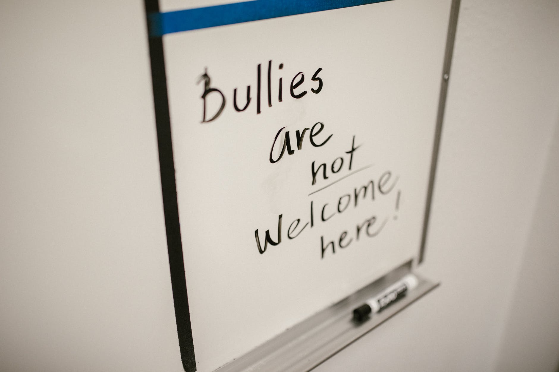 Dry erase board that says: "Bullies are not welcome here!"