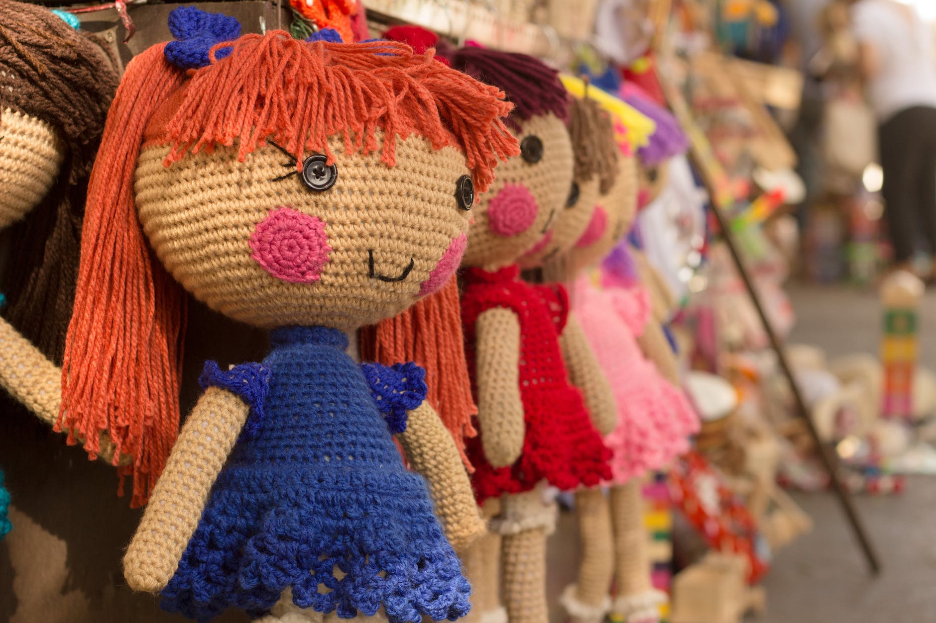 Rag dolls on a shelf.