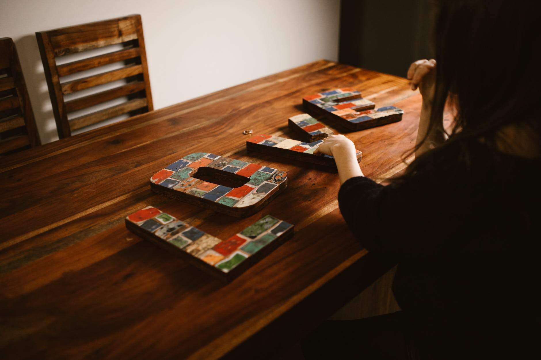 Person sitting at table spelling out "love".