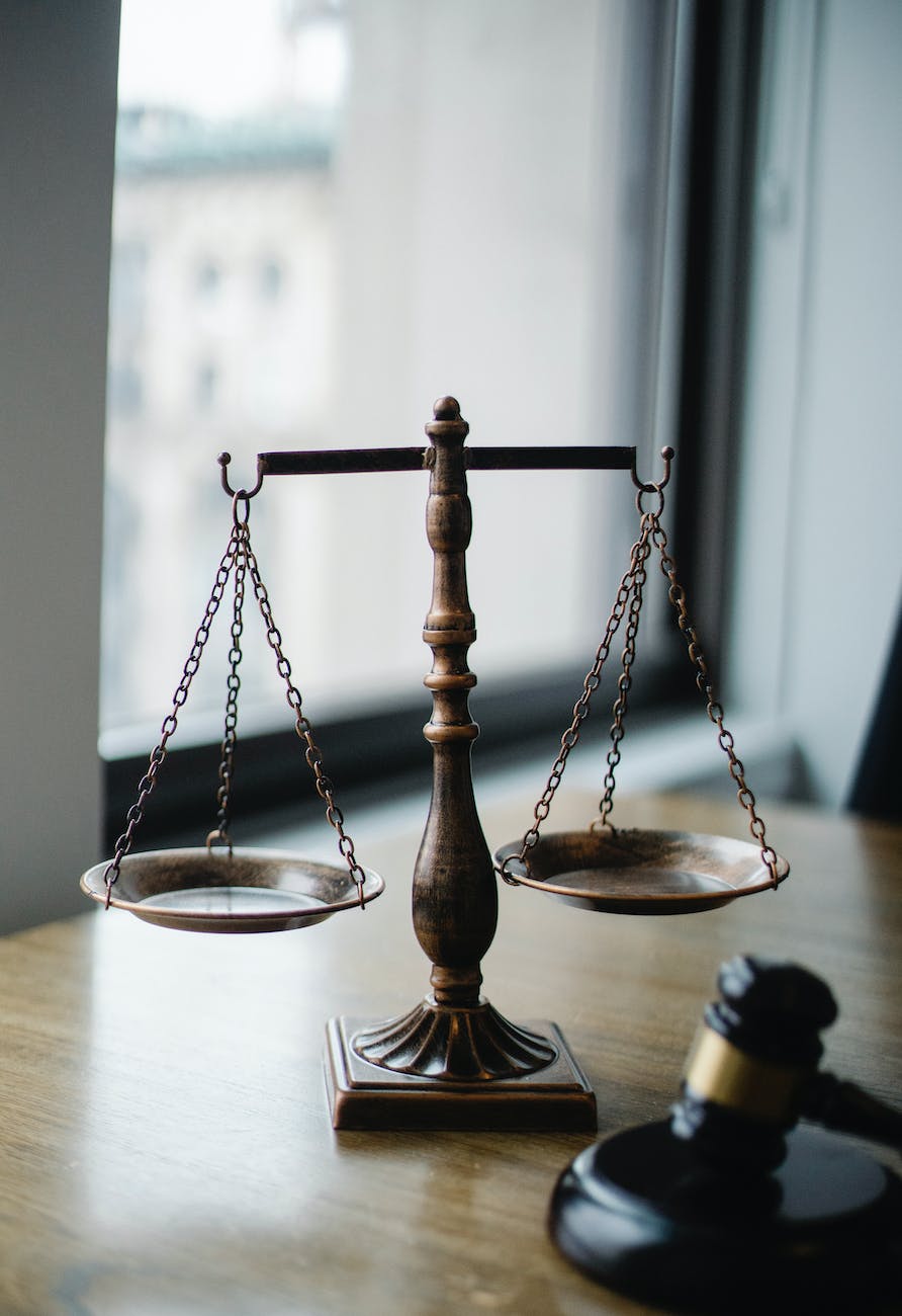 Scale on a desk with a gavel.